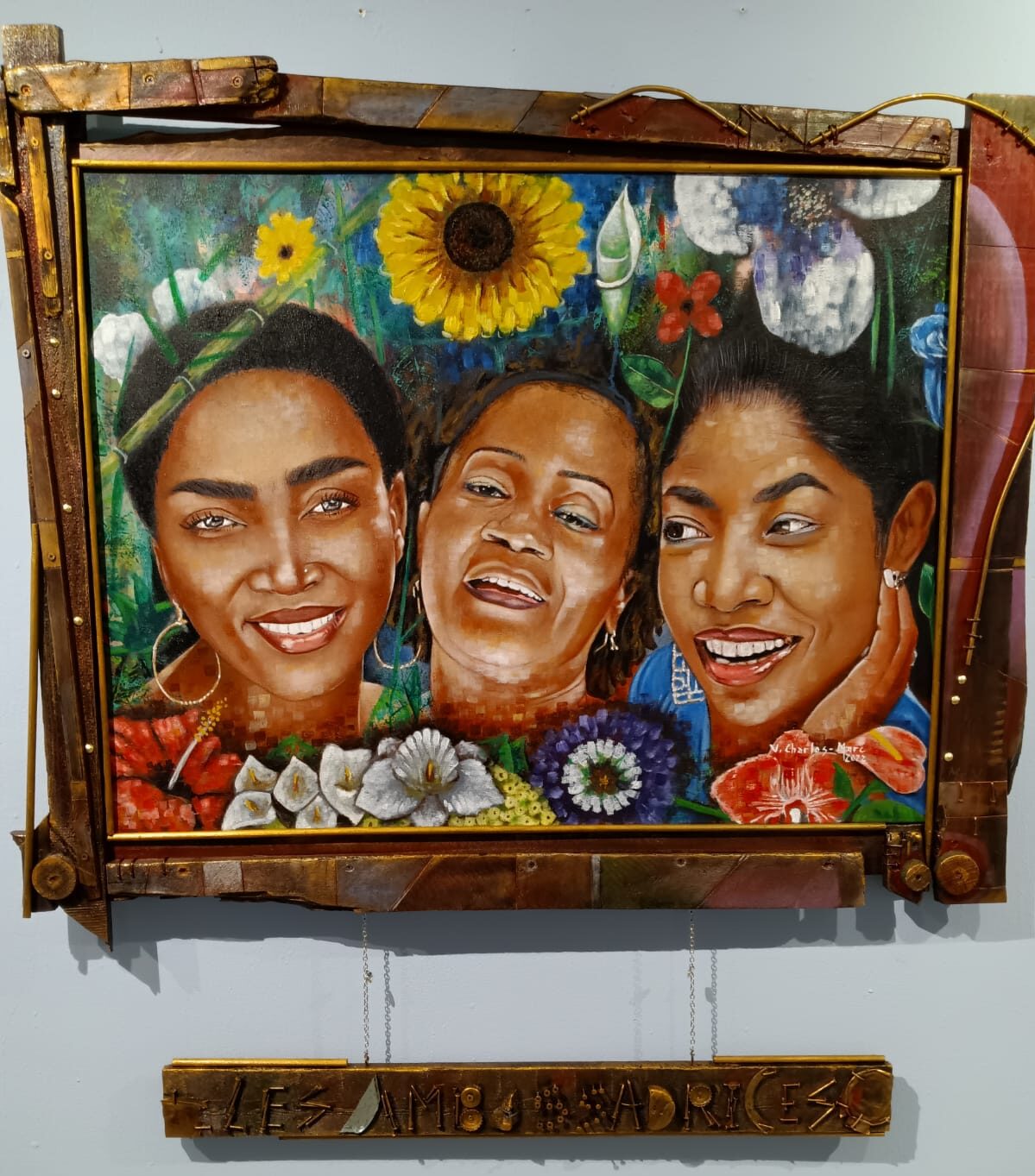 Painting features faces of three Haitian women with flowers and lush green background.